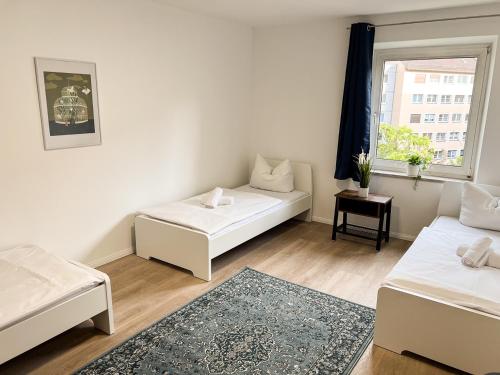 Zentrale Apartments in Bayreuth tesisinde bir odada yatak veya yataklar