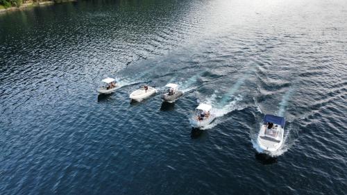 three boats in a body of water at Exclusive PrivateBeach - Explora Lake 3 in Omegna