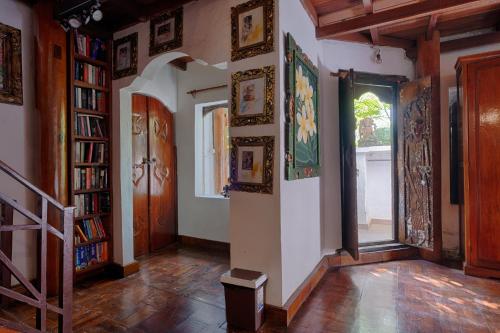 a room with a hallway with bookshelves and a window at Matahari Tulamben Resort, Dive & SPA in Tulamben