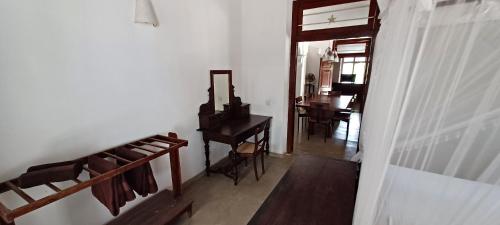 a room with a piano and a table with a mirror at WG - Wathurugama in Gampaha