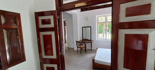 an open door to a room with a table at WG - Wathurugama in Gampaha