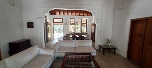 a living room with a couch and a table at WG - Wathurugama in Gampaha