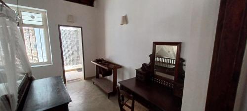 a living room with a mirror and a dresser at WG - Wathurugama in Gampaha