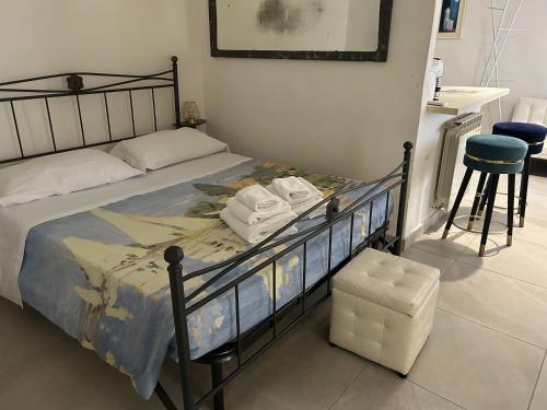 a bedroom with a bed with a black bed frame and a stool at Allegra Toscana - Affittacamere Guest house Arezzo in Arezzo