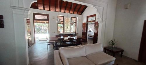 a living room with a couch and a dining room at WG - Wathurugama in Gampaha