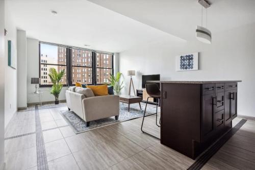a large living room with a couch and a table at 2BR Premium Downtown Suite in Detroit