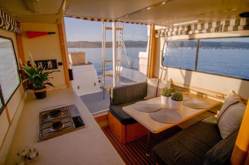 a kitchen and a table in the middle of a boat at Knysna Houseboats in Knysna