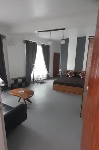 a bedroom with a bed and a table in it at Medajied Guest House in Shillong