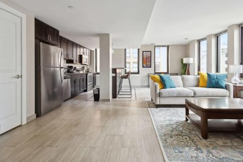 a large living room with a couch and a kitchen at 2BR Downtown Luxury Getaway in Detroit
