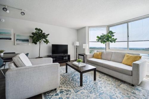 a living room with two couches and a tv at 2BR Executive City Suite With Gym & Pool in Arlington