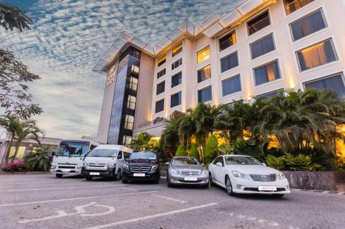 a group of cars parked in front of a hotel at Crowne Plaza Nairobi Airport by IHG in Nairobi