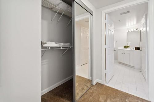 a bathroom with a mirror next to a closet at 2BR Executive City Suite With Gym & Pool in Arlington