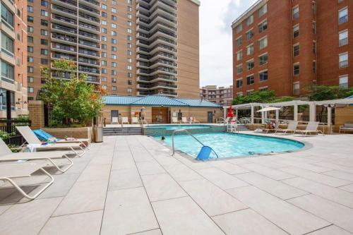 an outdoor swimming pool with a slide in a building at 2BR Executive City Suite With Gym & Pool in Arlington