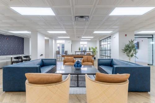 an office lobby with blue couches and a table at 3BR Premium Downtown Apartment with Office & Gym in Charlotte