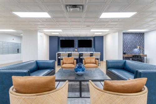 an office with couches and a table and chairs at 4BD Premium Family Apartment with Gym in Charlotte