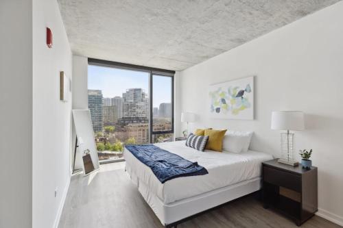 a bedroom with a large bed and a large window at 2BR Luxury River North Apartment With Wonderful Views in Chicago