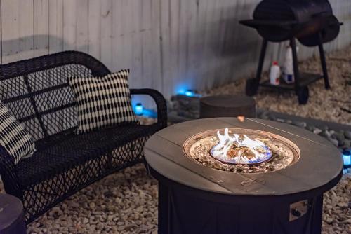 a fire pit with a table and a chair at Superb House by SeaWorld, Private POOL & GameRoom in San Antonio