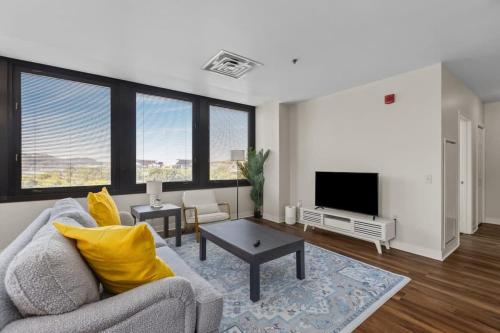 a living room with a couch and a tv at 2BR Downtown Apartment with Gym & Deck in Pittsburgh