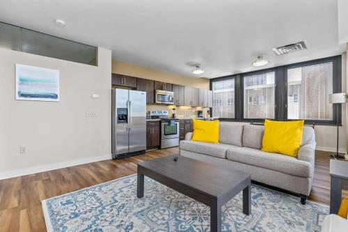 a living room with a couch and a table at 2BR Downtown Apartment with Gym & Deck in Pittsburgh
