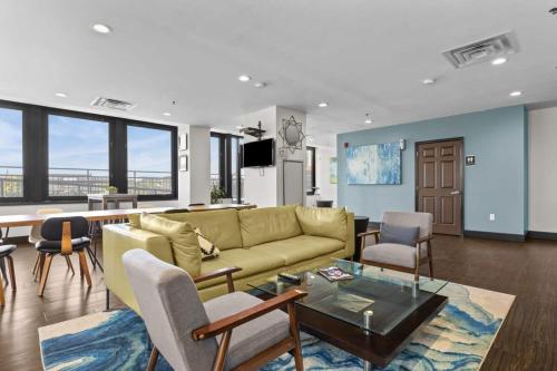 a living room with a couch and a table and chairs at 2BR Downtown Apartment with Gym & Deck in Pittsburgh