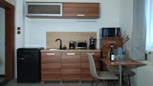 a small kitchen with a table and a refrigerator at Pension Fami Retro Design in Staré Splavy