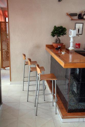 a kitchen with two bar stools and a counter at Hotel Levante in Guardamar del Segura