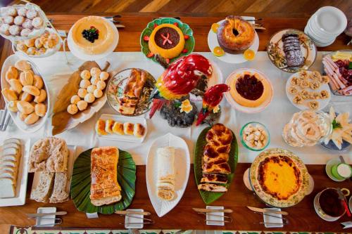 a table topped with lots of different types of food at Pousada Villa Allegra in Tiradentes