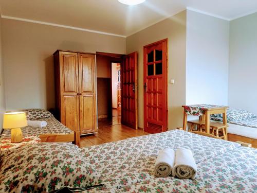a bedroom with a bed with two towels on it at Willa Wyrostek in Bańska Wyżna