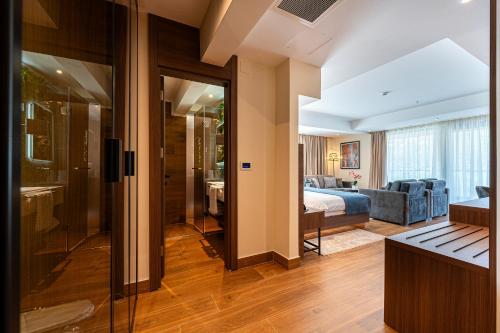 a hotel room with a bedroom and a bed at Hotel De‘Andros Virpazar in Virpazar