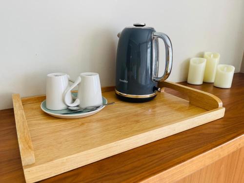 a coffee maker on a wooden tray on a counter at Luxury Stay in Orpington