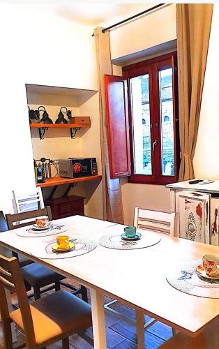 a kitchen with a table with plates and bowls on it at La plaza in Ollolai