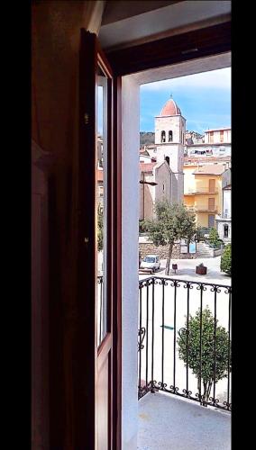 a view of a church from an open window at La plaza in Ollolai