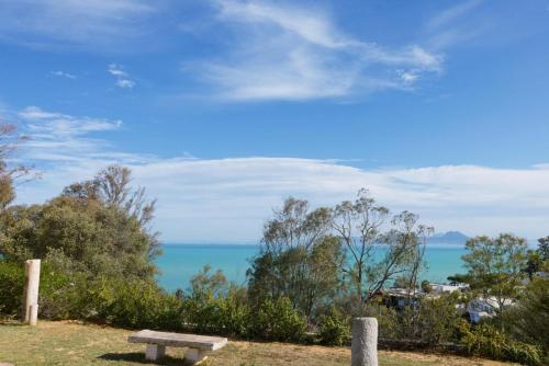 a bench on a hill overlooking the ocean at Suite Noor B&B Pool SidiBouSaid in Sidi Bou Saïd