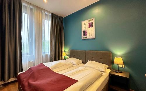 a bedroom with a large bed with a window at Trip Inn Hotel Düsseldorf Neuss in Neuss