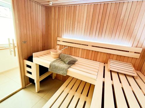 a sauna with a bench and a table in it at Ferienhaus Redensee in Pruchten