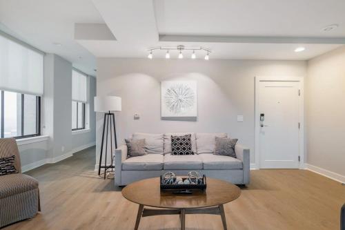 a living room with a couch and a table at 2B 2BA Distinguished Apartment Rooftop Pool & Gym in Baltimore