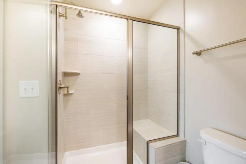a shower with a glass door in a bathroom at 2B 2BA Distinguished Apartment Rooftop Pool & Gym in Baltimore