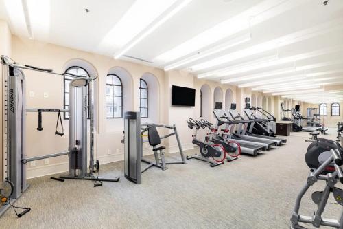a gym with several treadmills and cardio machines at 2B 2BA Distinguished Apartment Rooftop Pool & Gym in Baltimore