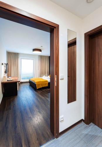 a room with a bed and a sliding glass door at Penzion v jízdárně in Olomouc