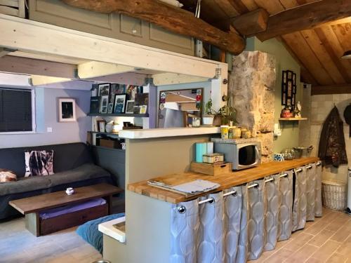 eine Küche und ein Wohnzimmer in einem winzigen Haus in der Unterkunft La Ressource in Montfort-sur-Argens
