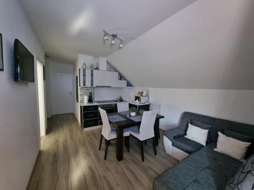 a living room with a table and a couch at Apartment Rosandić in Smoljanac