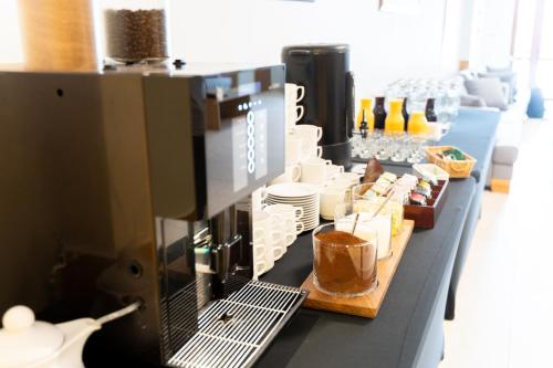 a counter with a coffee maker on top of it at Ośrodek Szkoleniowo-Wypoczynkowy "Leśnik" in Ustka