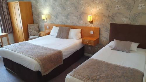 a hotel room with two beds at Alton House Hotel in Alton