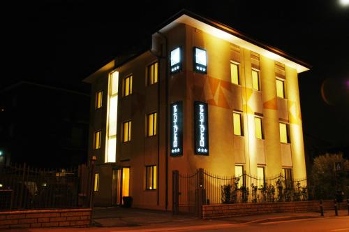 a large building with lights on it at night at Berghotel in Bergamo