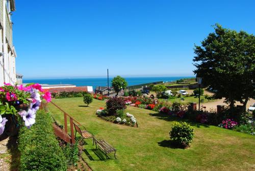 a park with flowers and the ocean in the background at The Curraghmore in Shanklin