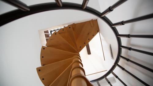 a view of a spiral staircase in a clock tower at Casa Enea - Luxury House Milano Navigli in Milan