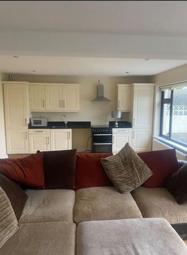 a living room with a couch and a kitchen at Islands View in Wexford