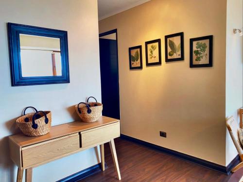 a room with a table with baskets on the wall at HOM I 6PAX Ski-Out en Valle Nevado Edif El Plomo EP607 in Farellones