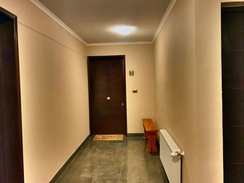 a hallway with a door and a wooden table at HOM I 6PAX Ski-Out en Valle Nevado Edif El Plomo EP607 in Farellones