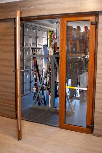 a glass door with a reflection of a room with skis at HOM I 6PAX Ski-Out en Valle Nevado Edif El Plomo EP607 in Farellones